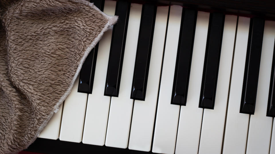 Piano keys being cleaned