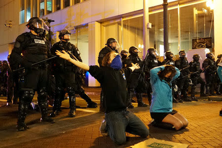 Demonstrators gesture in front of the police during a protest against the election of Republican Donald Trump as President of the United States in Portland, Oregon, U.S. November 11, 2016. REUTERS/Cole Howard