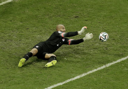 Tim Howard makes one of his 16 saves against Belgium on Tuesday. (AP)