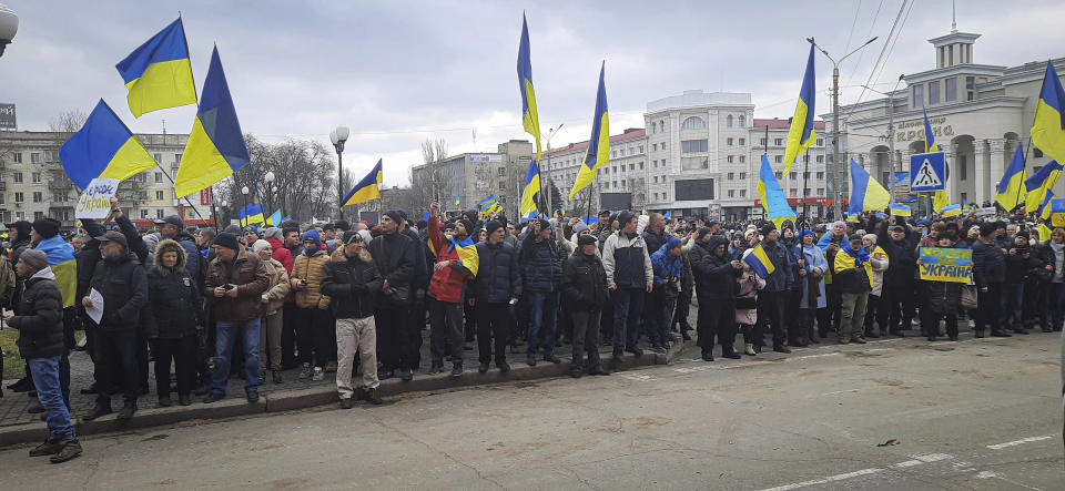 People wave Ukrainian flags during a rally against the Russian occupation in Svobody (Freedom) Square in Kherson, Ukraine, Saturday, March 5, 2022. Ever since Russian forces took the southern Ukrainian city of Kherson in early March, residents sensed the occupiers had a special plan for their town. Now, amid a crescendo of warnings from Ukraine that Russia plans to stage a sham referendum to transform the territory into a pro-Moscow "people's republic," it appears locals guessed right. (AP Photo/Olexandr Chornyi)