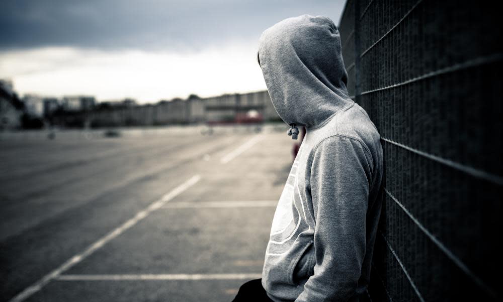 Boy leaning on fence