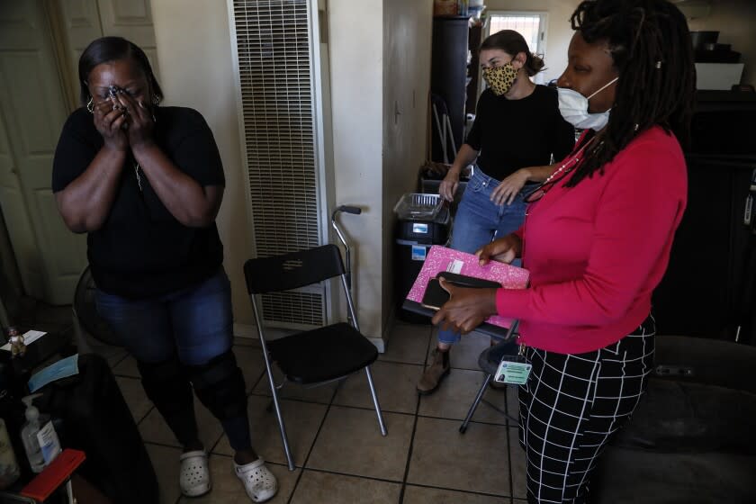 Mashawn Cross wipes tears from her eyes after visiting with Dana Vanderford, center, and Kourtni Gouche, right.