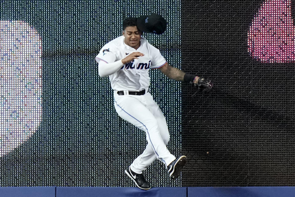 Miami Marlins center fielder Dane Myers goes against the wall to catch a fly ball hit by St. Louis Cardinals' Nolan Arenado during the fourth inning of a baseball game Wednesday, July 5, 2023, in Miami. (AP Photo/Lynne Sladky)