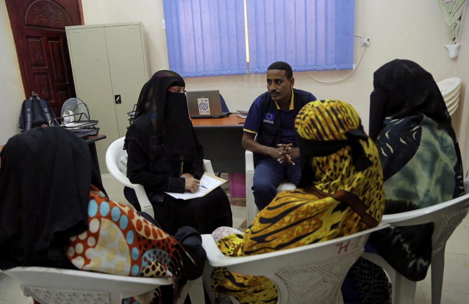 In this photo taken on Monday, Jan. 2, 2017, an employee speaks to Ethiopian migrants at International Organization for Migration center in the port city of Aden, Yemen. Despite Yemen’s civil war, migrants from Ethiopia and Saudi Arabia are streaming in, hoping to make their way to wealthy Saudi Arabia. Instead, they often meet torture, rape and imprisonment at the hands of smugglers. (AP Photo/Maad Al-Zikry)