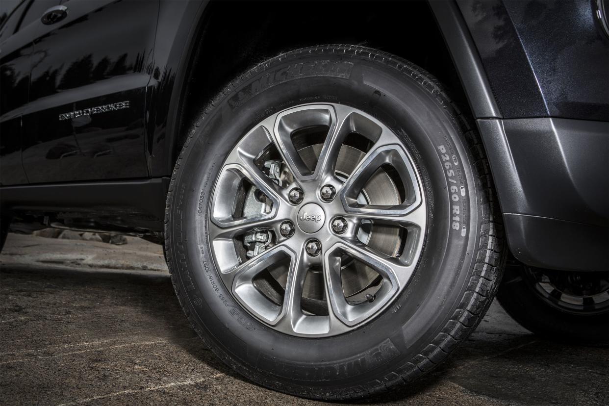 Close up of a wheel on a black 2014 Jeep Grand Cherokee Limited