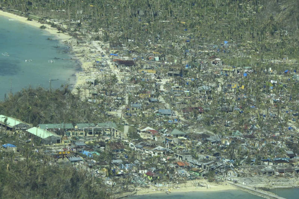 This photo provided by the Philippine Coast Guard, shows damaged houses caused by Typhoon Rai at a coastal village in Surigao del Norte province, southern Philippines on Friday, Dec. 17, 2021. A strong typhoon engulfed villages in floods that trapped residents on roofs, toppled trees and knocked out power in southern and central island provinces, where more than 300,000 villagers had fled to safety before the onslaught, officials said. (Philippine Coast Guard via AP)