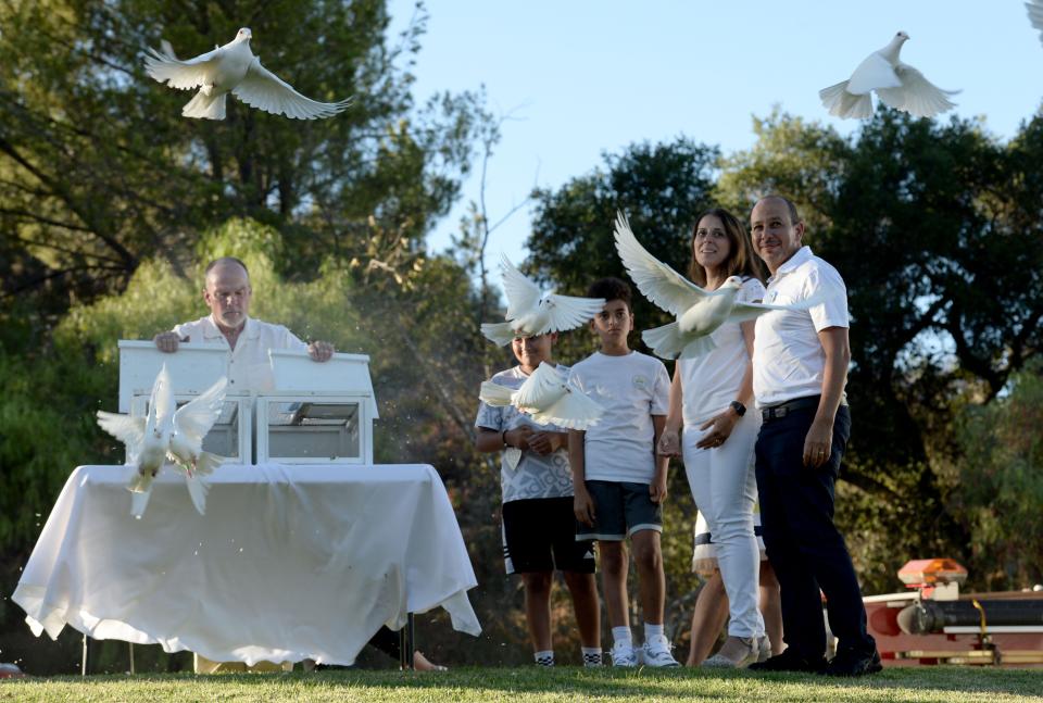 Karim and Nancy Iskander release doves in memory of their sons, Mark and Jacob, during a vigil at Three Springs Park in Westlake Village on Thursday. The event marked the second anniversary of the crash that killed the brothers in 2020.