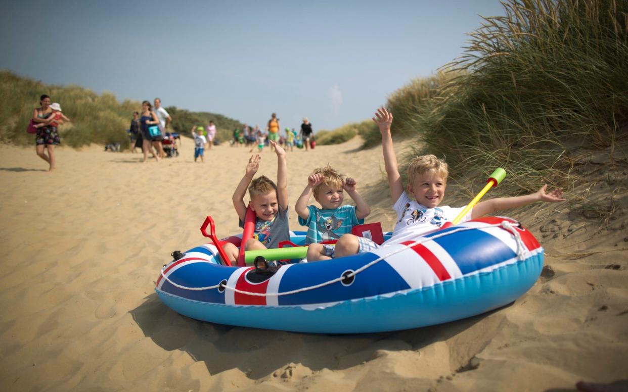 Children enjoy the hot weather on Camber Sands beach in Sussex  - Christopher Pledger