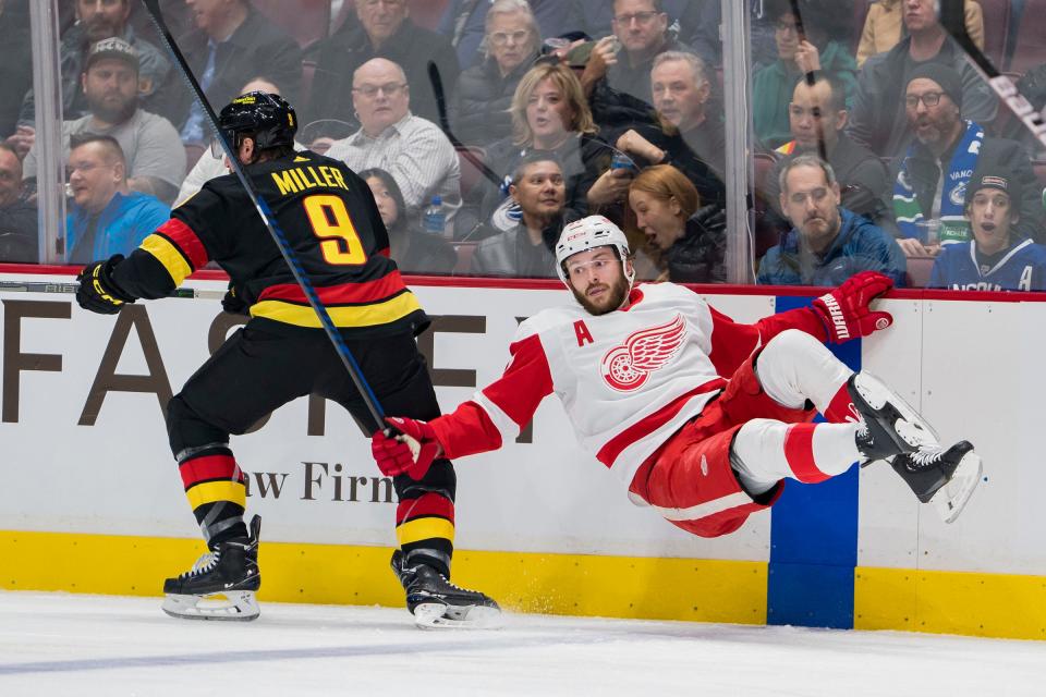 Red Wings forward Michael Rasmussen collides with Canucks forward J.T. Miller in the first period on Monday, Feb. 13, 2023, in Vancouver, British Columbia.