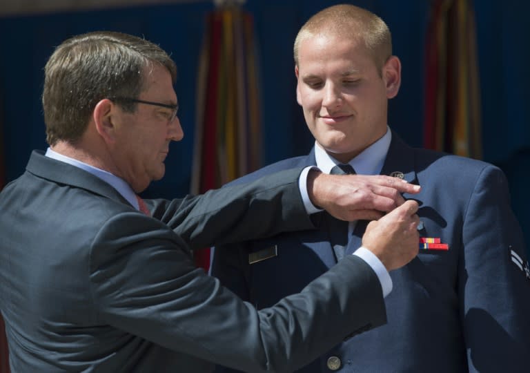 US Secretary of Defense Ashton Carter presents the Airman's Medal to Spencer Stone (right) at the Pentagon in Washington, DC on September 17, 2015