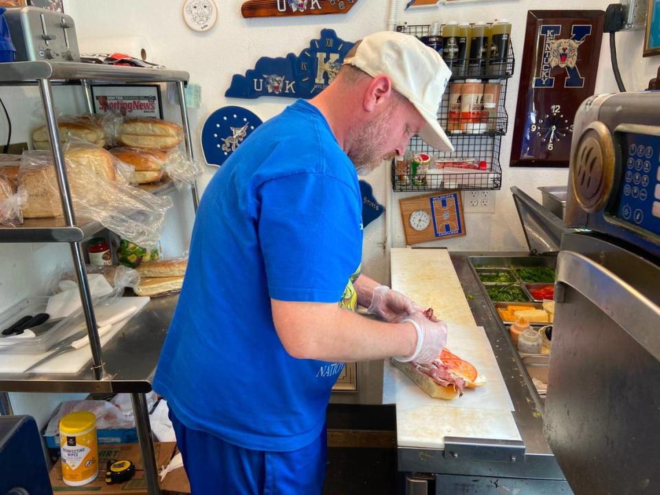 Big Blue Deli owner Zac Wright prepares “The Pope-Wich” sandwich at his restaurant on Thursday. Big Blue Deli is a UK athletics-themed deli located on Limestone Street in downtown Lexington.