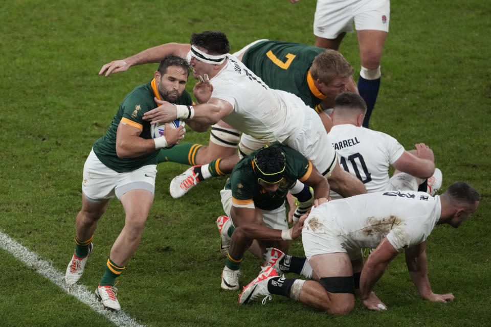 South Africa's Cobus Reinach, left, is tackled by England's Tom Curry during the Rugby World Cup semifinal match between England and South Africa at the Stade de France in Saint-Denis, outside Paris, Saturday, Oct, 21, 2023. (AP Photo/Themba Hadebe)