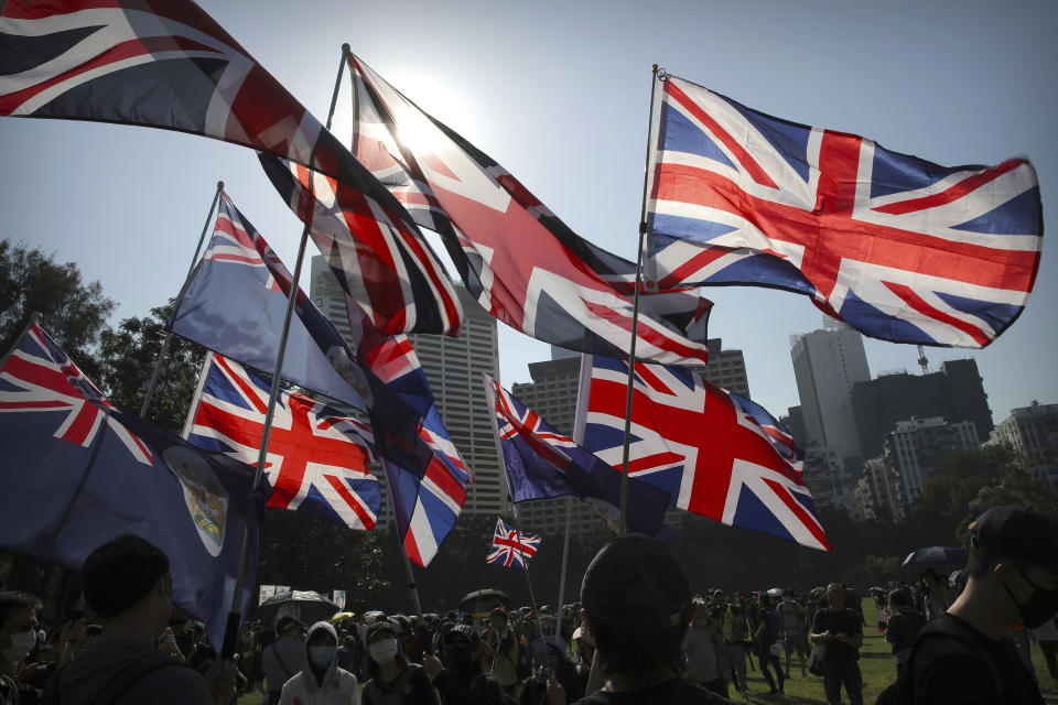 Demonstrators wave British flags during an anti-government protest in Hong Kong, Saturday, Nov. 2, 2019. Defying a police ban, thousands of black-clad masked protesters are streaming into Hong Kong's central shopping district for another rally demanding autonomy in the Chinese territory as Beijing indicated it could tighten its grip. (AP Photo/Kin Cheung)