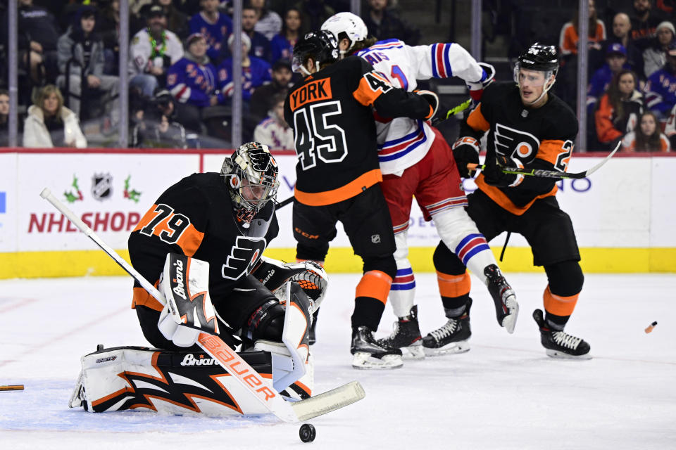 Philadelphia Flyers goaltender Carter Hart (79) makes a save during the first period of an NHL hockey game against the New York Rangers, Saturday, Dec. 17, 2022, in Philadelphia. (AP Photo/Derik Hamilton)