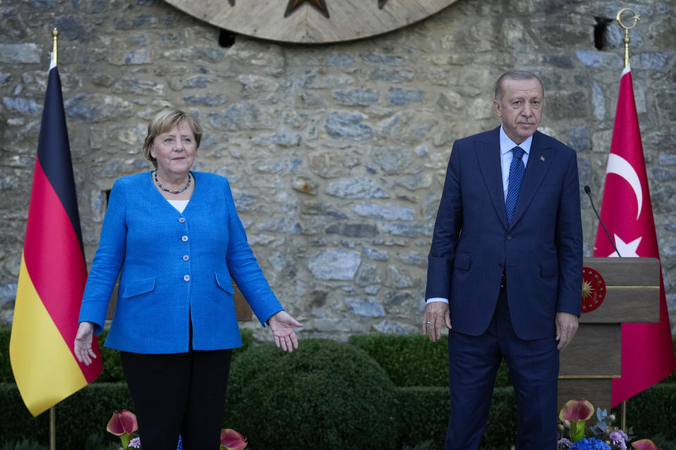 Turkey's President Recep Tayyip Erdogan, right, and German Chancellor Angela Merkel pose for the media at the end of a joint news conference following their meeting at Huber vila, Erdogan's presidential resident, in Istanbul, Turkey, Saturday, Oct. 16, 2021. The leaders discussed Ankara's relationship with Germany and the European Union as well as regional issues including Syria and Afghanistan. (AP Photo/Francisco Seco)