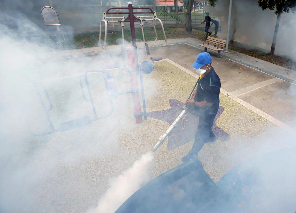 A worker fogs a community playground at a new Zika cluster area in Singapore September 1, 2016. REUTERS/Edgar Su