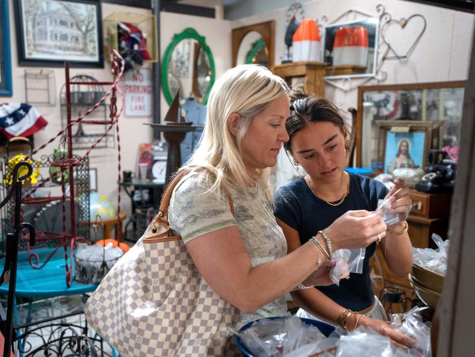 Brooke Bennett, right, of Brighton, and her mother Leighann Giannandrea, of Brighton, look over bagged vintage jewelry for sale at the Livingston Antique Outlet in Howell on Monday, July 1, 2024.