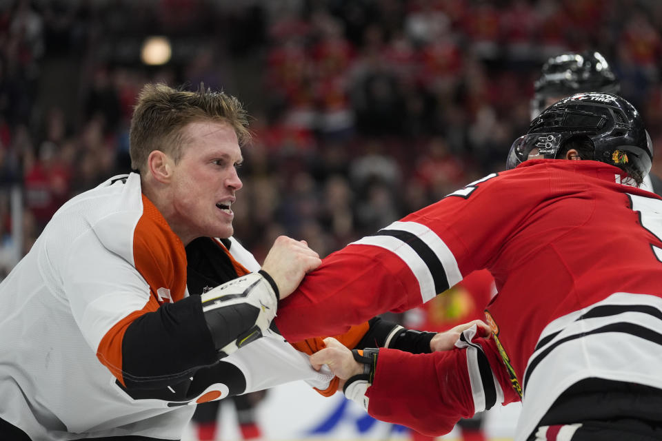 Chicago Blackhawks center Reese Johnson, right, and Philadelphia Flyers defenseman Nick Seeler go at it during the third period of an NHL hockey game Wednesday, Feb. 21, 2024, in Chicago. The Flyers won 3-1. (AP Photo/Erin Hooley)