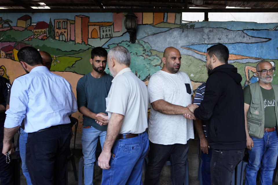 Relatives of Taline al-Hamoui and her mother Rihab who were killed after a boat sank with migrants receive condolences after their funeral, in Tripoli, Lebanon, Wednesday, April 27, 2022. A week ago, a boat carrying around 60 Lebanese trying to escape their country and reach Europe sank in the Mediterranean after colliding with a Navy ship. At least seven people are known dead and at least six are missing. The tragedy underscored the desperation among many Lebanese after the collapse of their country's economy.(AP Photo/Hassan Ammar)