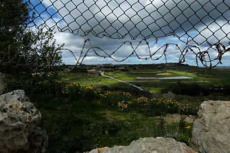 The hole in the fence leading to the lookout point used by one of the three men accused of the assassination of anti-corruption journalist Daphne Caruana Galizia, is seen in Bidnija, Malta, February 21, 2018. REUTERS/Darrin Zammit Lupi