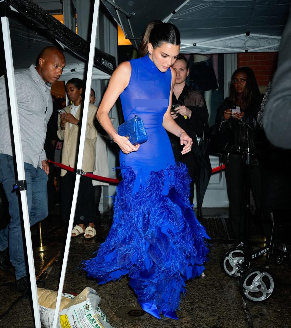 Kendall Jenner paired her blue dress with slicked-back hair and matching accessories.