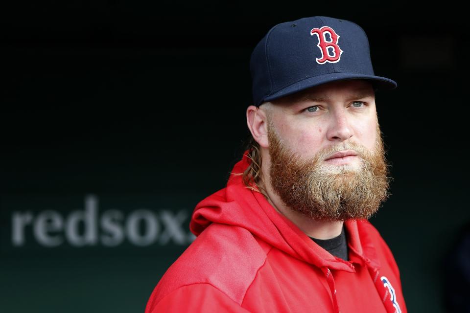 Boston Red Sox pitcher Andrew Cashner stands in the dugout before a baseball game against the Los Angeles Dodgers in Boston, Sunday, July 14, 2019. (AP Photo/Michael Dwyer)