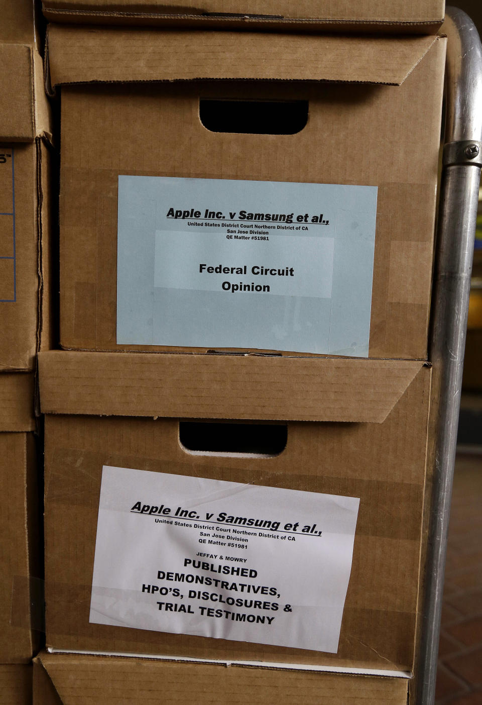 Boxes containing documents related to the Apple Inc. v. Samsung case sit outside of a federal courthouse in San Jose, Calif., Monday, April 28, 2014. Closing arguments in the high-stakes patent-infringement case are scheduled to begin Monday, with the two tech giants accusing each other, once again, of ripping off designs and features. At stake: $2 billion if Samsung loses, a few hundred million if Apple loses. (AP Photo/Jeff Chiu)