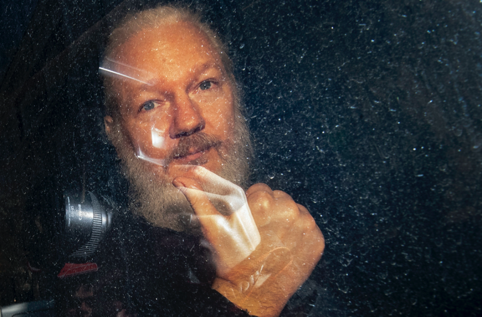 <em>Assange gives a thumbs up to photographers following his arrest (PA)</em>