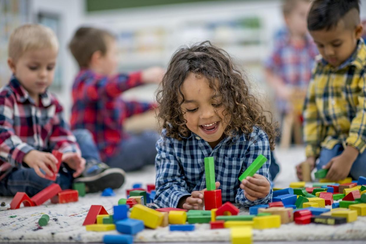 A group of preschool kids are playing indoors at a daycare center