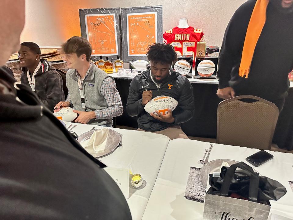 Current Tennessee players Dylan Sampson, Jake Merklinger and Mike Matthews sign autographs for fans at Bearden Banquet Hall on Feb. 23, 2024.