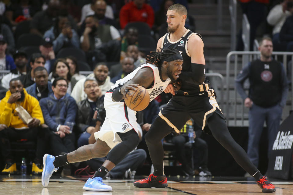 Los Angeles Clippers forward Montrezl Harrell (5) drives on Atlanta Hawks center Alex Len (25) in the first half of an NBA basketball game Wednesday, Jan. 22, 2020, in Atlanta, Ga. (AP Photo/Brett Davis)