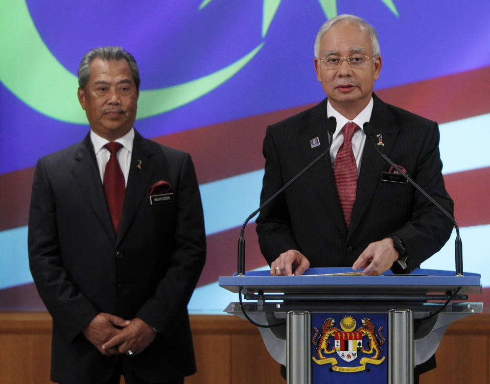 FILE - Malaysian Prime Minister Najib Razak, right, speaks during the announcement of his new cabinet lineup as his deputy Muhyiddin Yassin listens in Putrajaya, Malaysia, May 15, 2013. Najib Razak on Tuesday, Aug. 23, 2022 was Malaysia’s first former prime minister to go to prison -- a mighty fall for a veteran British-educated politician whose father and uncle were the country’s second and third prime ministers, respectively. The 1MDB financial scandal that brought him down was not just a personal blow but shook the stranglehold his United Malays National Organization party had over Malaysian politics. (AP Photo/Lai Seng Sin, file)