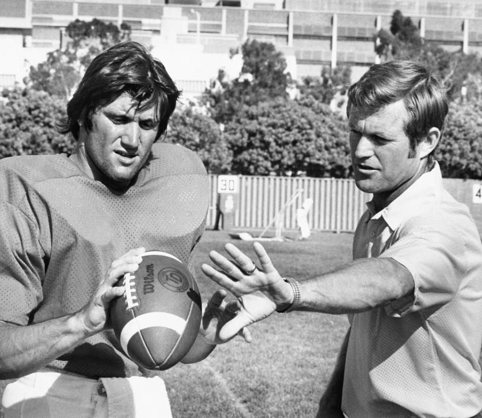 Head coach Dick Vermeil of UCLA talks with his veteran quarterback, John Sciarra, as he told reporters on Sept. 3, 1975 in Los Angeles, Sciarra is "the best college football player in America." He said the 5-10, 178-pounder has "an NFL arm." (AP Photo/JLR)