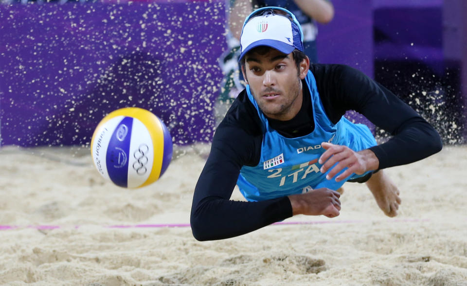 Daniele Lupo from Italy dives for a ball during the Beach Volleyball match against Switzerland at the 2012 Summer Olympics, Sunday, July 29, 2012, in London. (AP Photo/Petr David Josek)