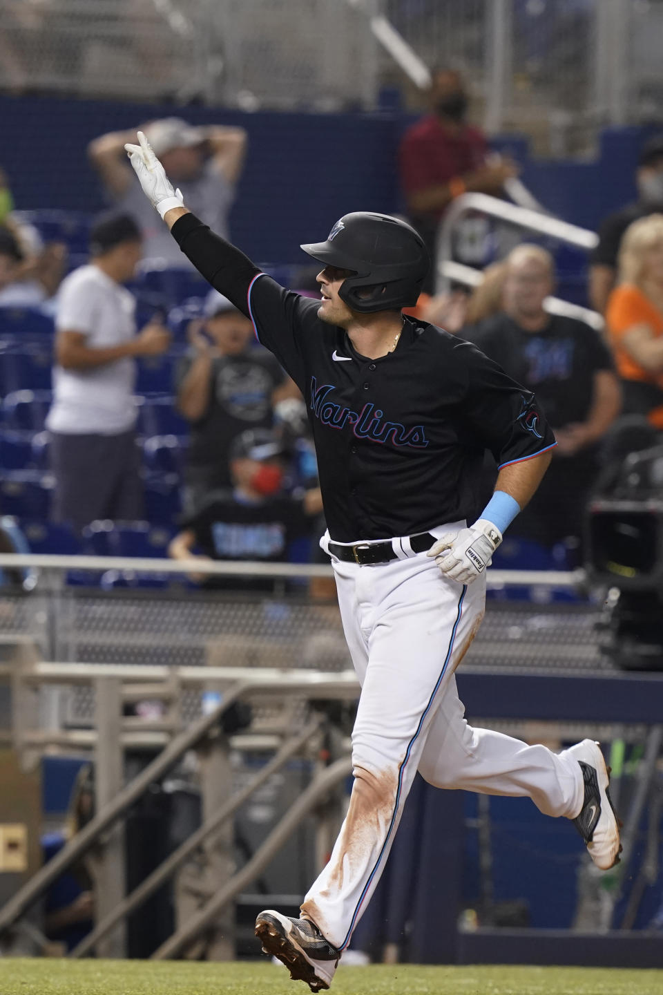 Miami Marlins Nick Fortes raises his hand to the crowd after hitting a two-run home run during the fifth inning of the team's baseball game against the Pittsburgh Pirates, Saturday, Sept. 18, 2021, in Miami. (AP Photo/Marta Lavandier)