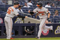 Baltimore Orioles' Austin Hays (21) celebrates his solo home run with third base coach Tony Mansolino (36) during the third inning of the team's baseball game against the New York Yankees, Monday, Aug. 2, 2021, in New York. (AP Photo/Mary Altaffer)