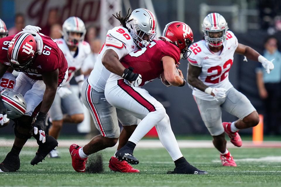 Ohio State defensive tackle Jaden McKenzie tackles Indiana quarterback Brendan Sorsby.