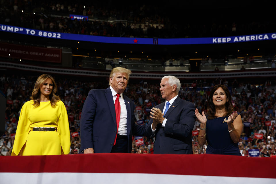 President Donald Trump and first lady Melania Trump stand with Vice President Mike Pence and Karen Pence during Trump's re-election kickoff rally at the Amway Center, Tuesday, June 18, 2019, in Orlando, fla. (AP Photo/Evan Vucci)