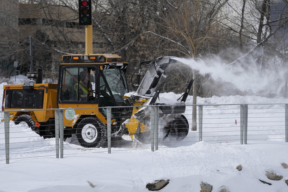 A snow plower clears streets from snow, Friday, Feb. 24, 2023, in Bloomington, Minn. (AP Photo/Abbie Parr)
