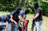 Investigators are seen during a police operation in Oullins, near Lyon, France May 27, 2019. REUTERS/Emmanuel Foudrot