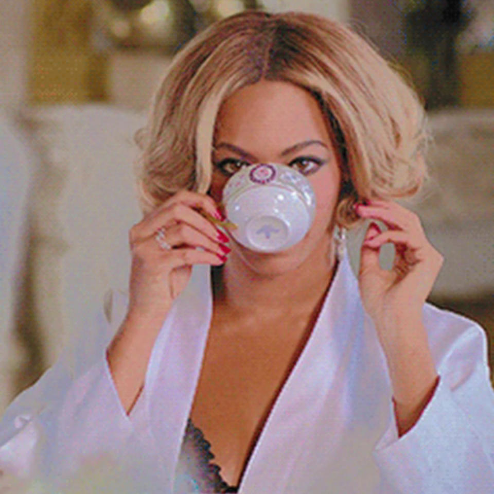 Beyoncé in her "Partition" music video drinking tea