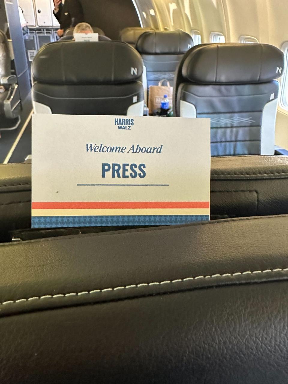 On the plane with Tim Walz this week, the press cabin was separated by rows of Walz and his security personnel (Andrew Feinberg)