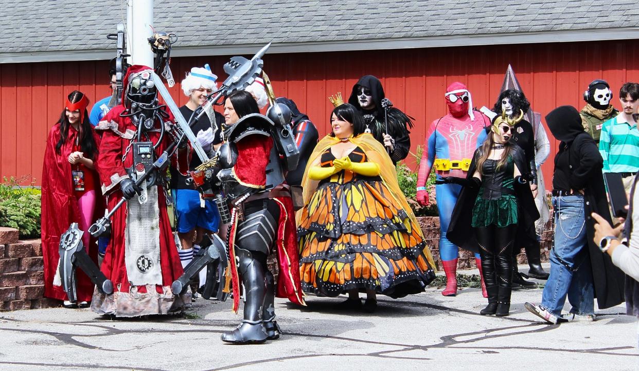 Monroe Pop Fest attendees line up for the convention's annual cosplay contest. Southgate resident Eli Ingram won for his character costume of a tech priest from the tabletop game Warhammer 40,000.
