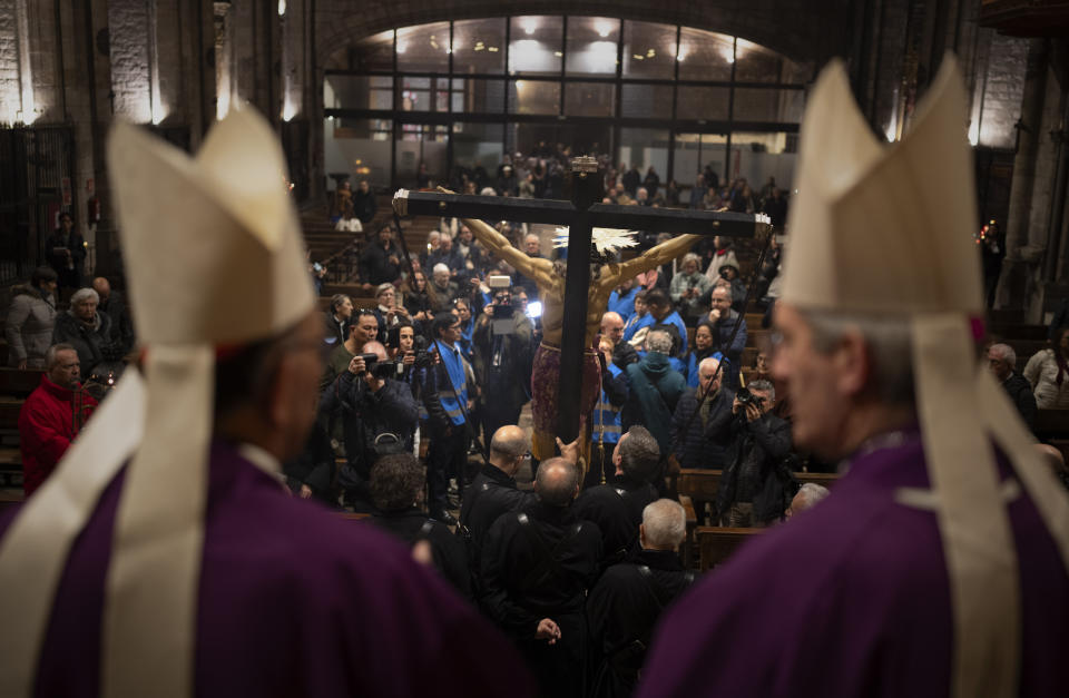 Worshippers carry an image of the Holy Christ of the Blood inside the Santa Maria del Pi church after a procession asking for rain through the streets of downtown Barcelona, Spain, Saturday, March 9, 2024. A religious procession organised by the Brotherhoods of the Archdiocese of Barcelona marched through the city downtown asking for rain coinciding with the rainiest day of the year. Spain's northeastern region of Catalonia declared a drought emergency for the area of around 6 million people including the city of Barcelona. (AP Photo/Emilio Morenatti)