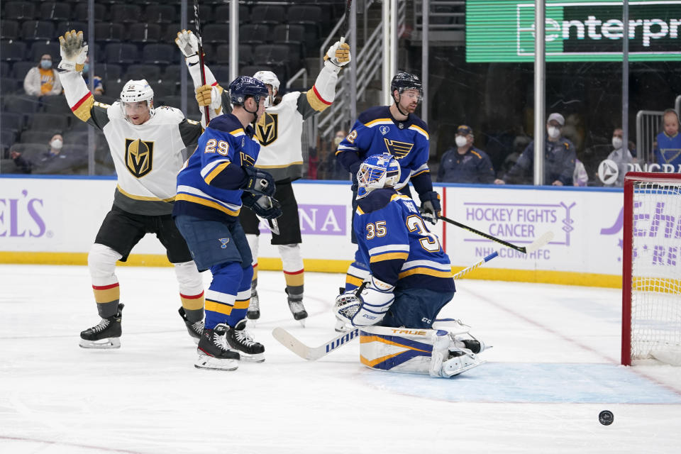 Vegas Golden Knights' Tomas Nosek, left, celebrates after scoring past St. Louis Blues goaltender Ville Husso (35) and Vince Dunn (29) during the first period of an NHL hockey game Monday, April 5, 2021, in St. Louis. (AP Photo/Jeff Roberson)