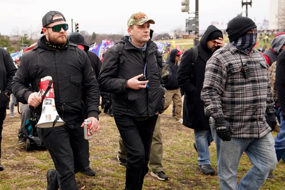 In this Jan. 6, 2021 photo, Proud Boys members Ethan Nordean, left, Zachary Rehl and Joseph Biggs walk toward the U.S. Capitol in Washington, in support of President Donald Trump.