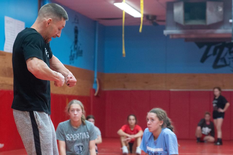 Emphasizing a technique to his team, Shawnee Heights wrestling coach Chad Parks takes advantage of the short practice last Wednesday.