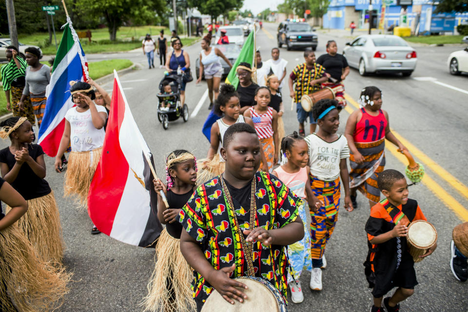 FILE - In this June 19, 2018, file photo, Zebiyan Fields, 11, at center, drums alongside more than 20 kids at the front of the Juneteenth parade in Flint, Mich. Juneteenth celebration started with the freed slaves of Galveston, Texas. Although the Emancipation Proclamation freed the slaves in the South in 1863, it could not be enforced in many places until after the end of the Civil War in 1865. (Jake May/The Flint Journal via AP, File)