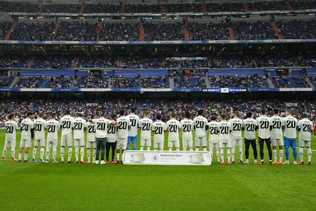 Players of Real Madrid wear jerseys with the name of team mate Vinicius Junior for a Spanish La Liga soccer match between Real Madrid and Rayo Vallecano at the Santiago Bernabeu stadium in Madrid, Spain, Wednesday, May 24, 2023. (AP Photo/Manu Fernandez)