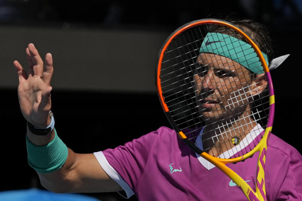 Rafael Nadal of Spain gestures to Adrian Mannarino of France during their fourth round match at the Australian Open tennis championships in Melbourne, Australia, Sunday, Jan. 23, 2022. (AP Photo/Simon Baker)